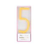Yellow slim number 5 birthday candle packaged in a clear box by Meri Meri.