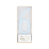 Light blue slim number 6 birthday candle packaged in a clear box by Meri Meri.