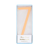 Peach-orange slim number 7 birthday candle packaged in a clear box by Meri Meri.