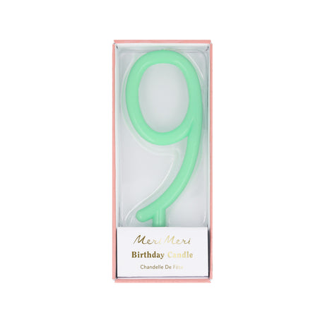 Mint green number 9 birthday candle packaged inside a pink box with Meri Meri branding.