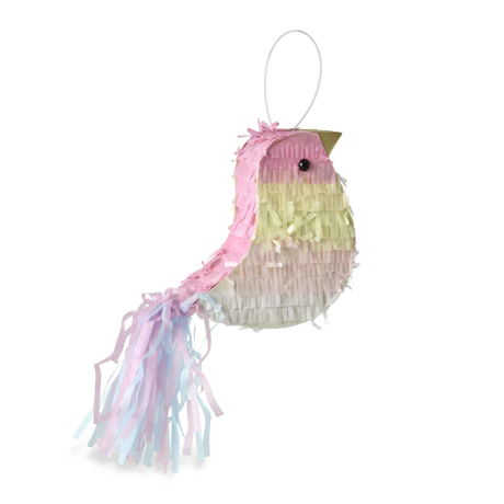 A colorful bird-shaped piñata with pastel pink, yellow, and white fringes and a long tail. The background is solid white, highlighting the piñata.