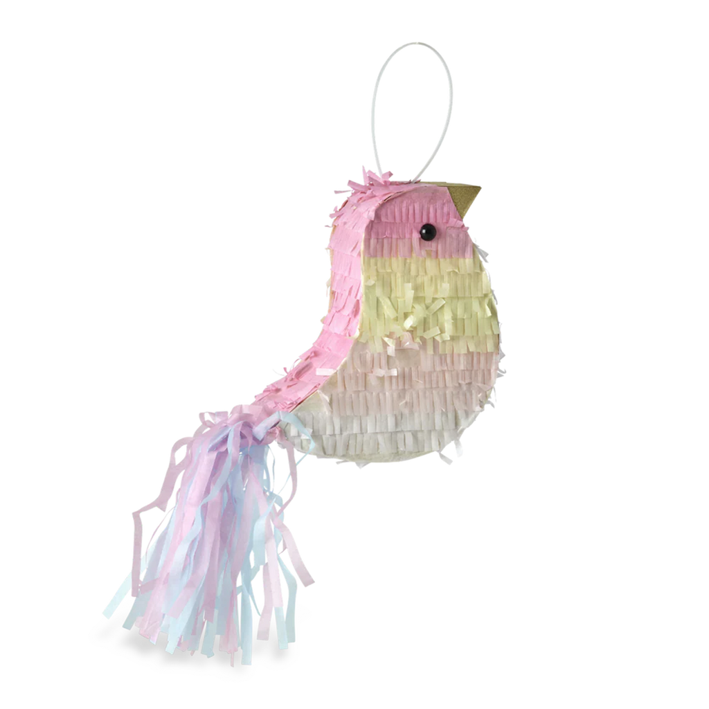 A colorful bird-shaped piñata with pastel pink, yellow, and white fringes and a long tail. The background is solid white, highlighting the piñata.