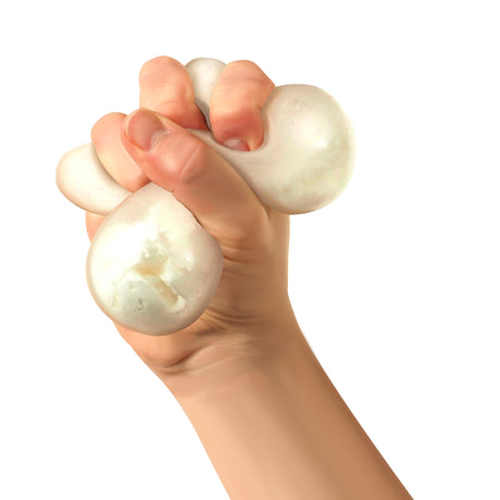 Hand squeezing a white snowball-textured stress ball, illustrating tactile sensory play and stress relief on a white background.