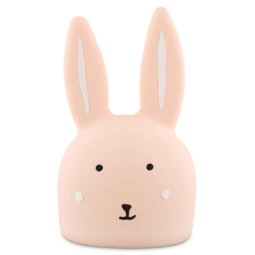Cute bunny-shaped night light with soft pink color, simple facial features, long ears, and a calm expression. Emits a gentle, soothing glow.