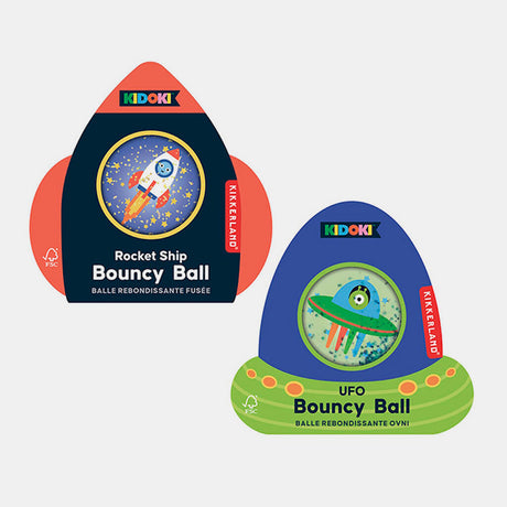 Two Kikkerland bouncy ball packages: one with a rocket ship theme on a starry backdrop, the other features a green UFO. Playful, space-themed designs.