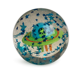 A clear globe with floating blue stars encases a colorful UFO with a green alien inside, against a black background. Playful and whimsical.