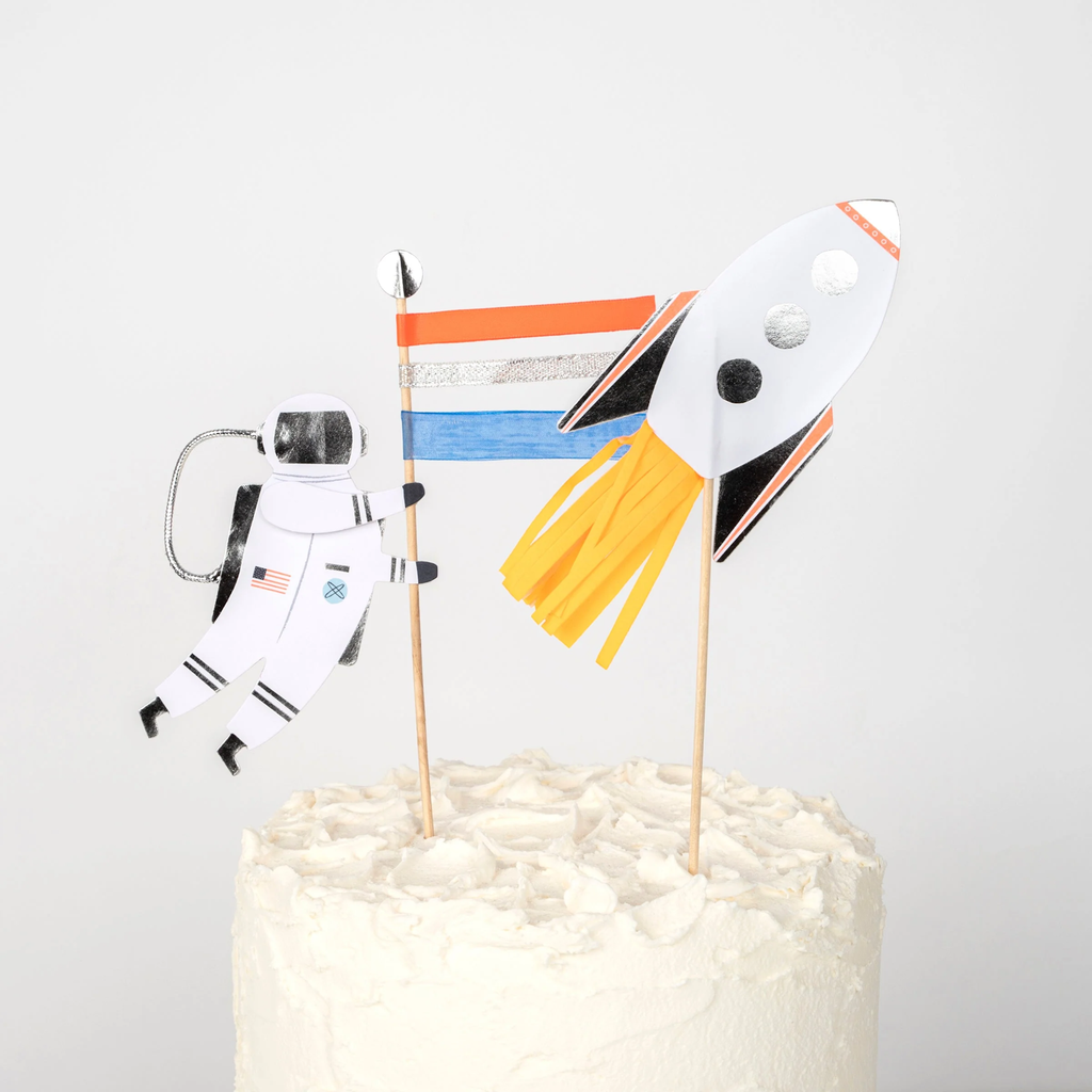 A set of space-themed cake decorations featuring rockets, stars, and planets, perfect for adding a cosmic touch to cakes.