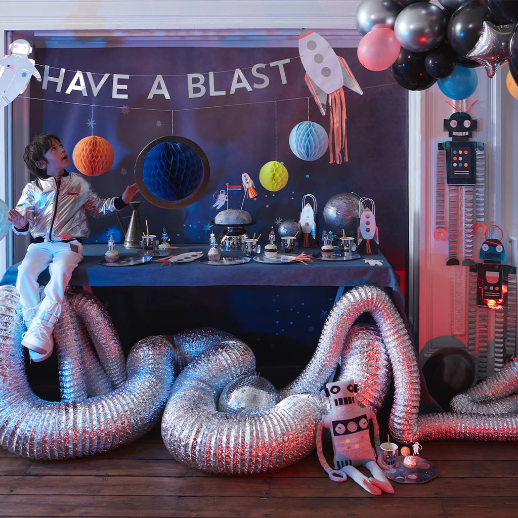A cosmic-themed decoration featuring colorful cutouts of planets, rockets, and stars, perfect for space-themed parties and rooms.