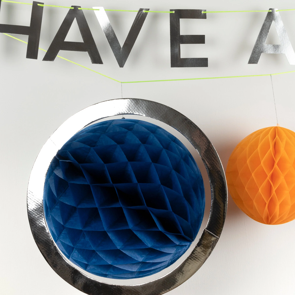 A cosmic-themed decoration featuring colorful cutouts of planets, rockets, and stars, perfect for space-themed parties and rooms.