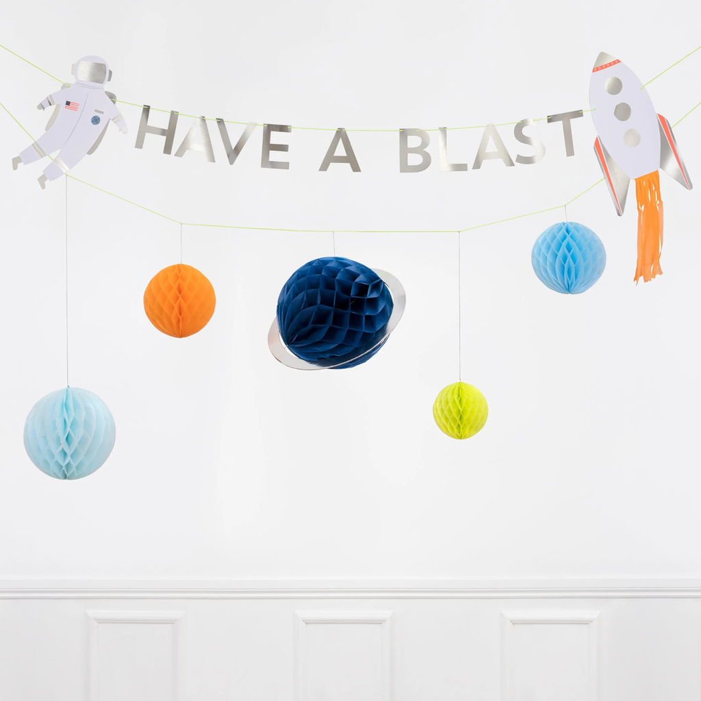 A cosmic-themed decoration featuring colorful cutouts of planets, rockets, and stars, perfect for space-themed parties and rooms.