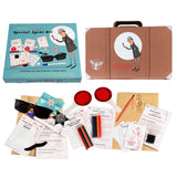 A special agent kit with sunglasses, magnifying glass, secret messages, and various investigation tools, all in a decorative case.