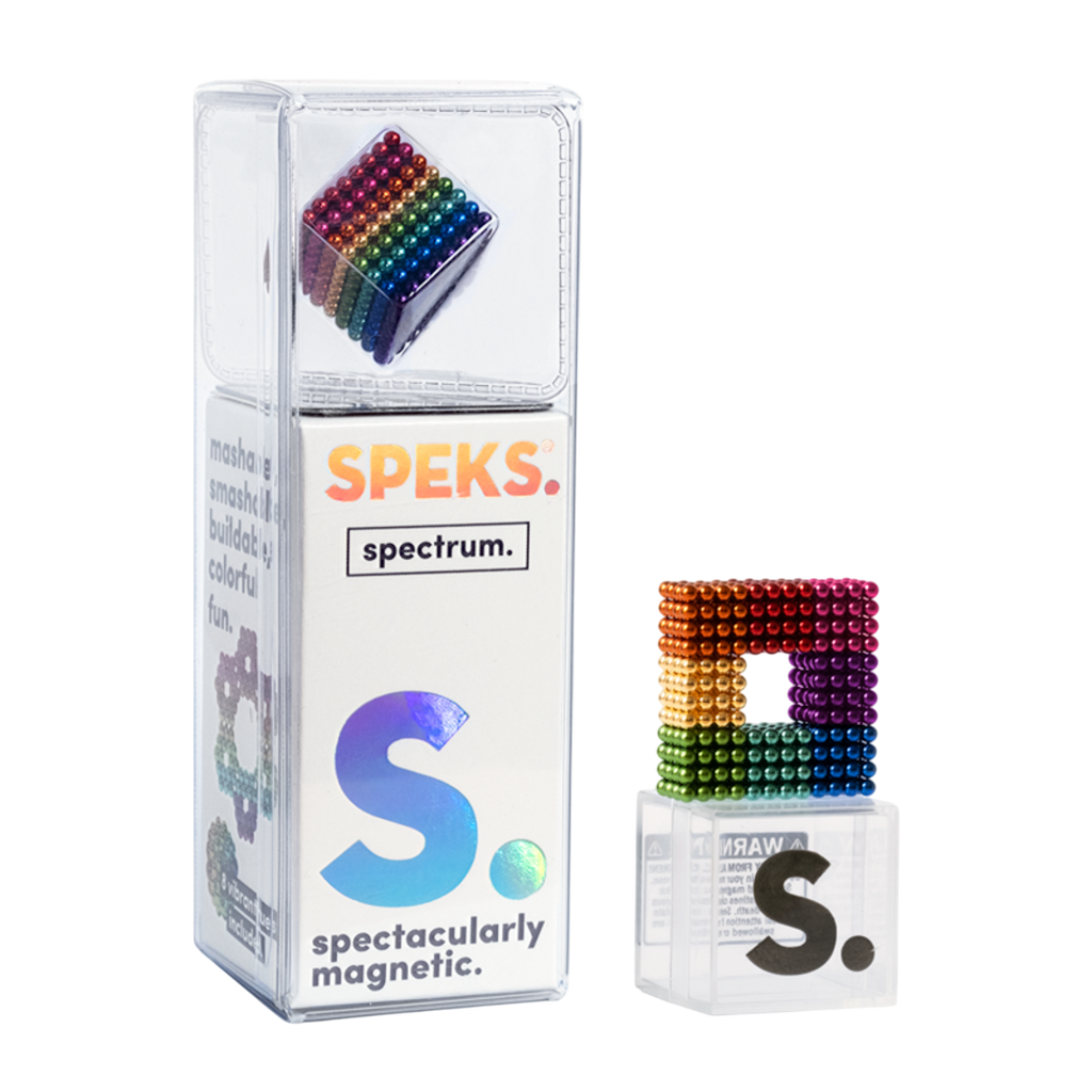 Packaging for Speks magnetic balls with a colorful, cube-shaped magnet displayed. The box reads "SPEKS. spectrum. spectacularly magnetic." on a white background.