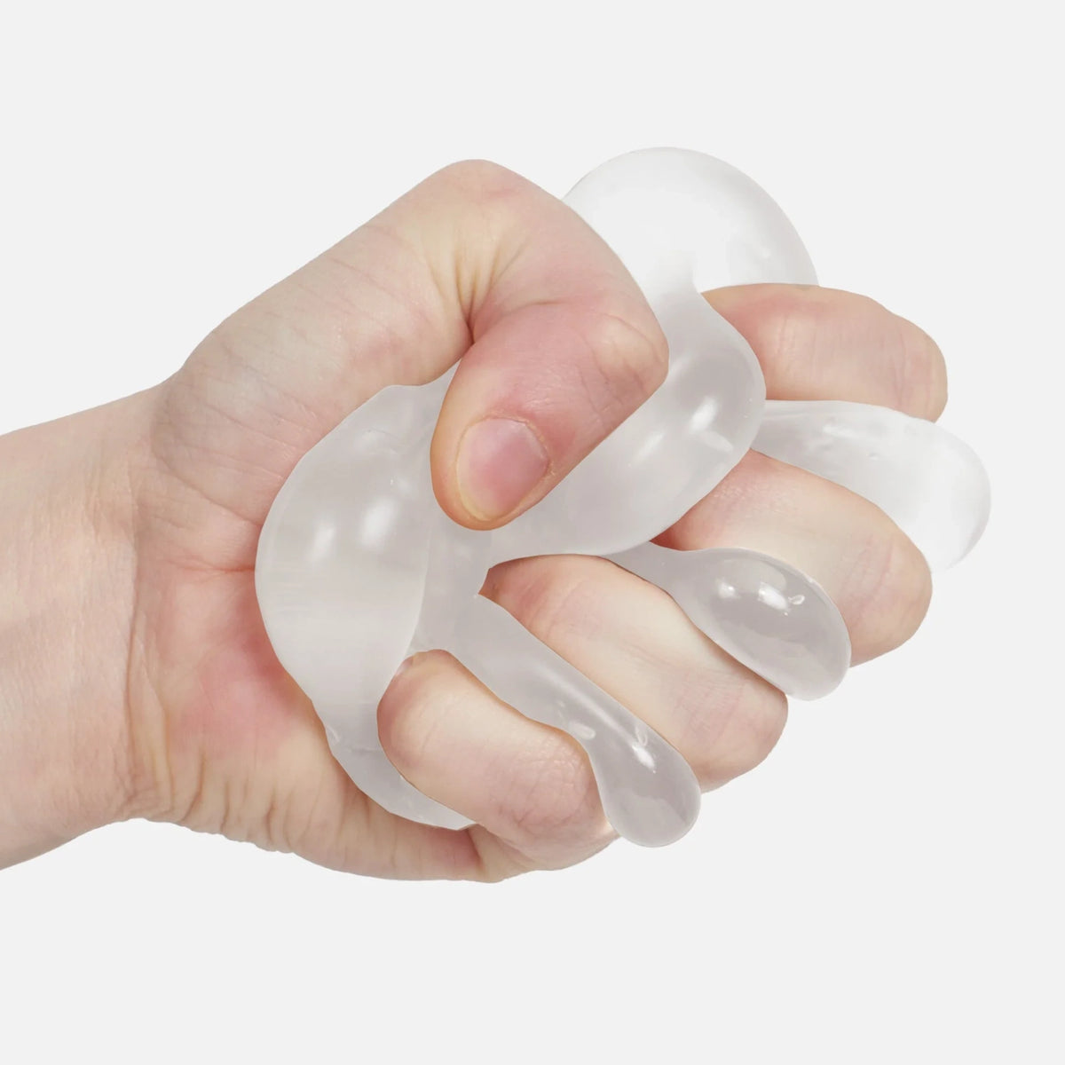 Hand squeezing a translucent white Speks Gump ghost memory gel stress ball.