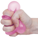 Pink Speks Loop Gump memory gel stress ring being squeezed in a hand.