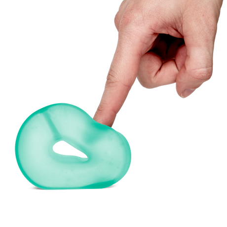 Speks Loop Gump seaglass memory gel stress ring squished by a finger on a black background.