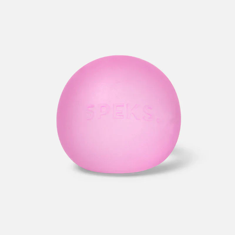 A pink stress ball labeled "SPEKS" centered on a plain, light gray background, conveying a sense of calm and simplicity.