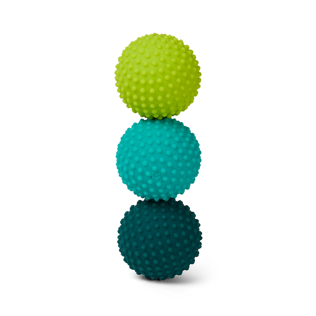 Three textured balls stacked vertically against a white background. From top to bottom: light green, teal, and dark teal. The tone is playful and vibrant.