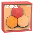 Three polygonal fidget desk magnets in a box. The magnets are red, orange, and peach, set against a soft background. The box has a modern, playful design.