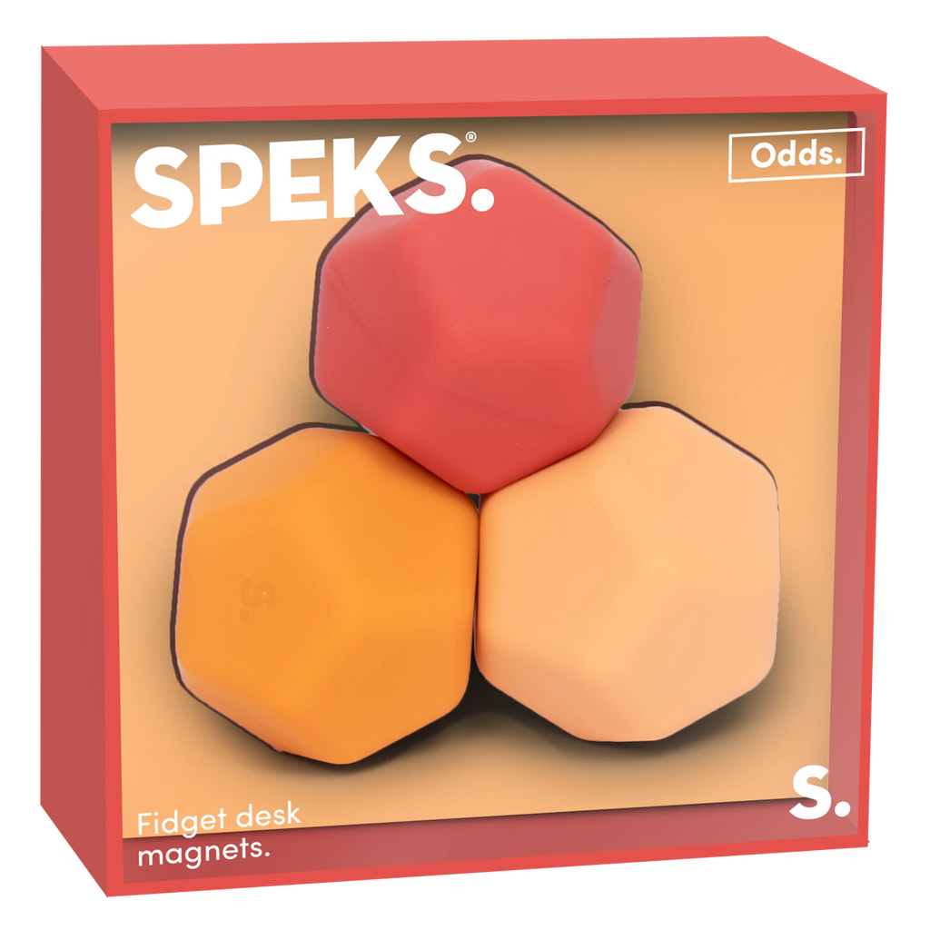 Three polygonal fidget desk magnets in a box. The magnets are red, orange, and peach, set against a soft background. The box has a modern, playful design.