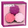 Three textured, round fidget desk magnets in purple, pink, and light pink are placed in a magenta box labeled "Speks Odds." The tone is playful.