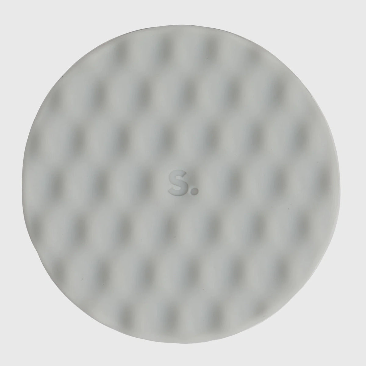 Circular light grey silicone sensory sticker with a mesh, dimpled textured pattern.