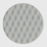 Circular light grey silicone sensory sticker with a mesh, dimpled textured pattern.