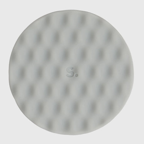 Circular light grey silicone sensory sticker with a mesh, dimpled textured pattern.