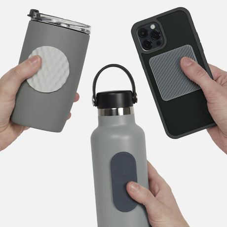 Three hands holding items with silicone sensory stickers on a grey travel mug, bottle, and phone.