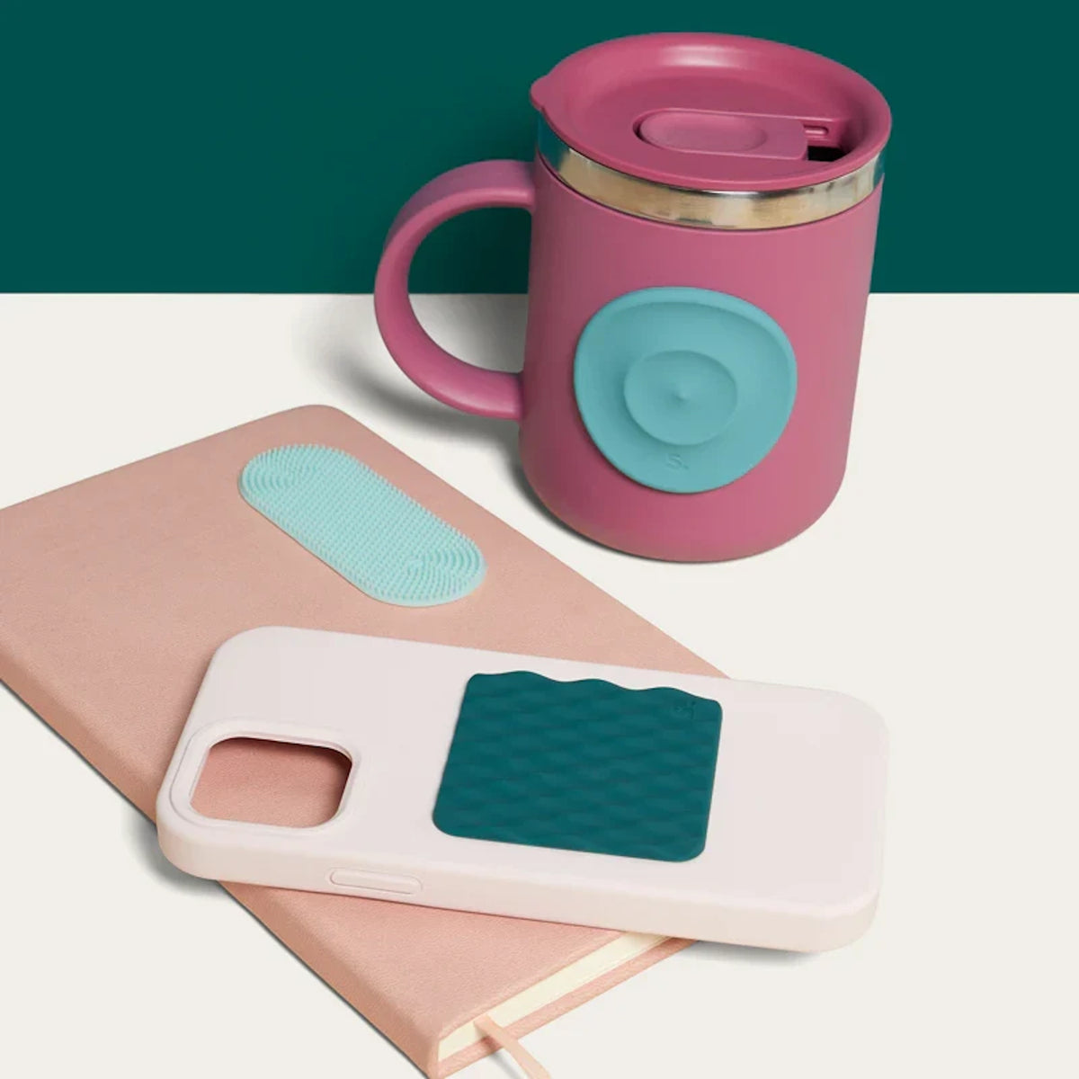 Pink insulated mug, notebook, and phone case featuring silicone sensory stickers in teal and green tones.