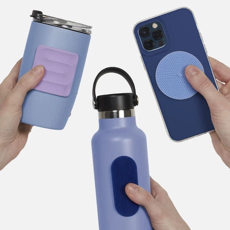 Hands holding blue items with textured silicone sensory stickers attached.