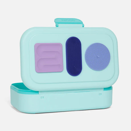 Three distinct textured silicone sensory stickers attached inside the lid of a mint green pencil box.