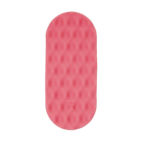Oval pink silicone sensory sticker with a mesh dimpled texture and an "S." logo near the bottom.