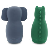 Two silicone baby bottles; one blue with an elephant design, and one green with a crocodile design. Both have textured details and a smooth finish.