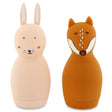 Two silicone water bottles shaped like animals. The left is a pink rabbit with long ears, and the right is a brown fox with closed eyes. They are cute and whimsical.
