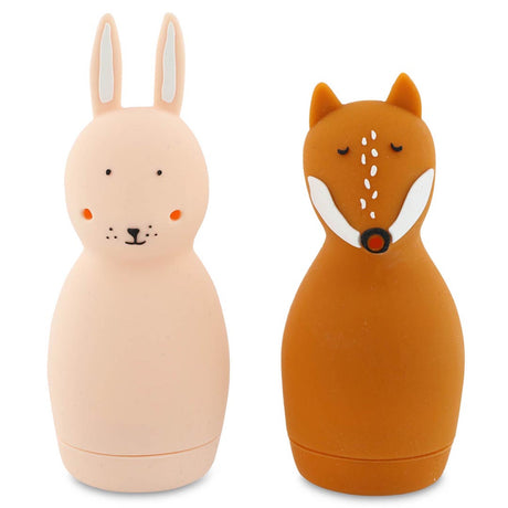 Two silicone water bottles shaped like animals. The left is a pink rabbit with long ears, and the right is a brown fox with closed eyes. They are cute and whimsical.