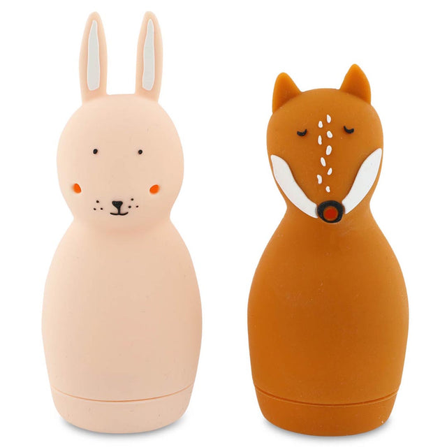 Two silicone water bottles shaped like animals. The left is a pink rabbit with long ears, and the right is a brown fox with closed eyes. They are cute and whimsical.