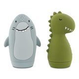 Two cute silicone animal toys: a smiling light blue shark and a green T-rex dinosaur on a white background.