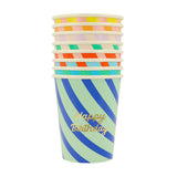 A stack of colorful striped paper cups, with "Happy Birthday" written in gold on the front cup.