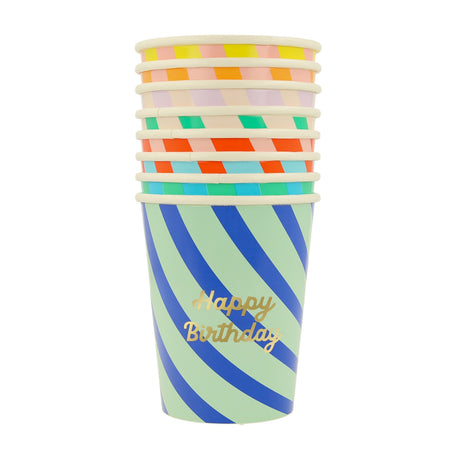 A stack of colorful striped paper cups, with "Happy Birthday" written in gold on the front cup.