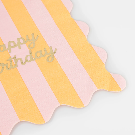 Pink and yellow striped napkin corner showing gold foil text and scalloped edges.