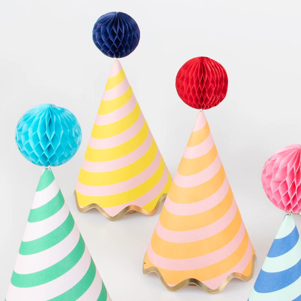 A set of colorful cone-shaped hats with bold stripe patterns and pom-pom tops, perfect for festive celebrations.