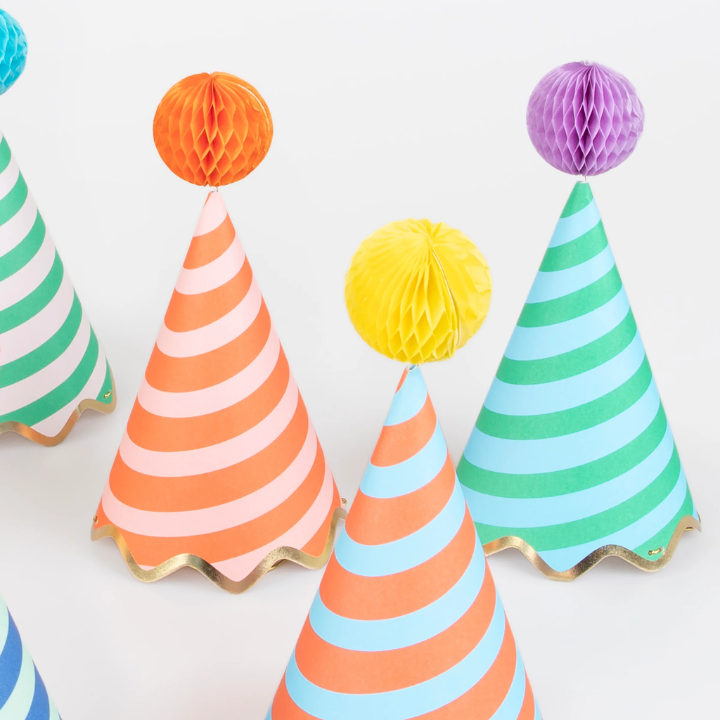 A set of colorful cone-shaped hats with bold stripe patterns and pom-pom tops, perfect for festive celebrations.