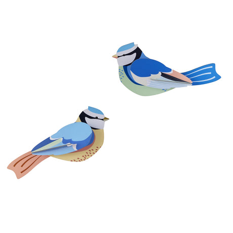 Two colorful, stylized paper birds with blue, green, and orange hues. The birds face opposite directions against a plain white background.