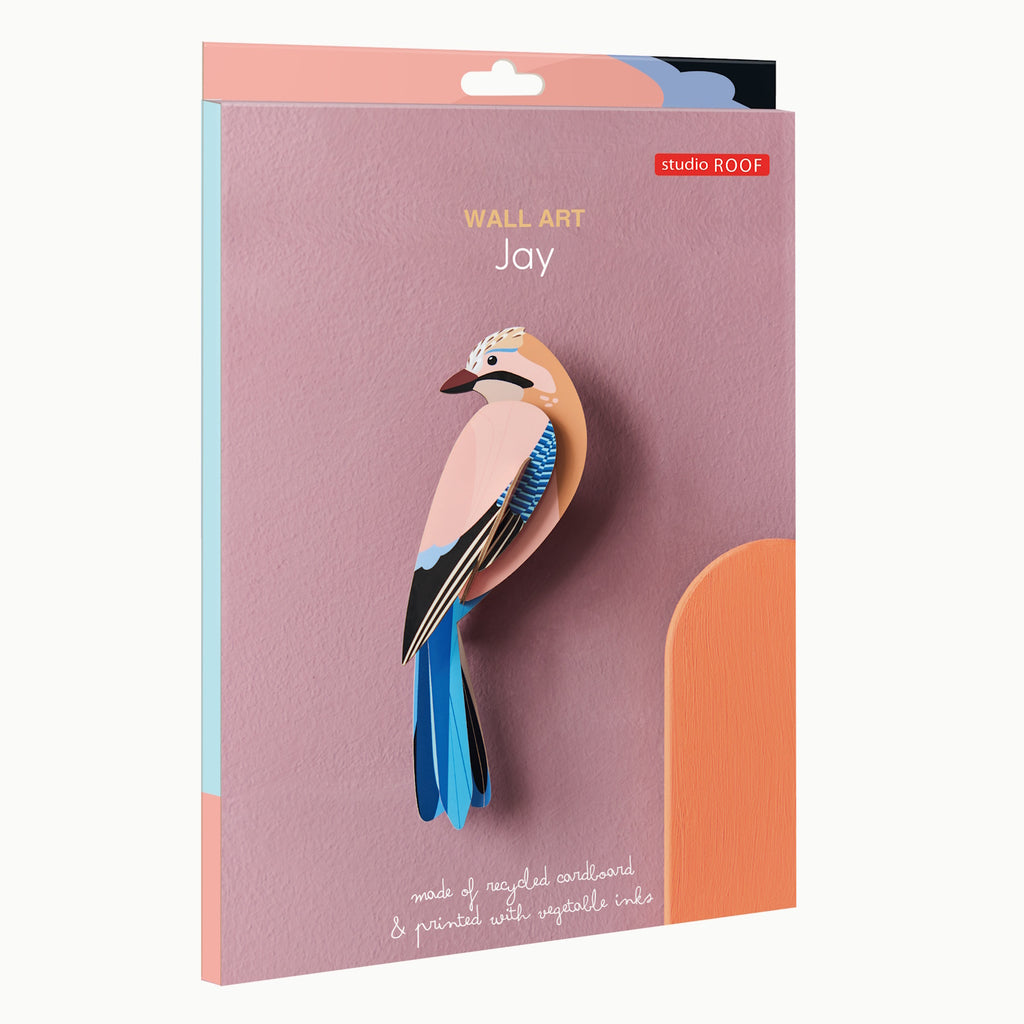 Pink and blue jay wall art made from recycled cardboard on a mauve background. Text reads "Wall Art Jay" and "Printed with vegetable inks."