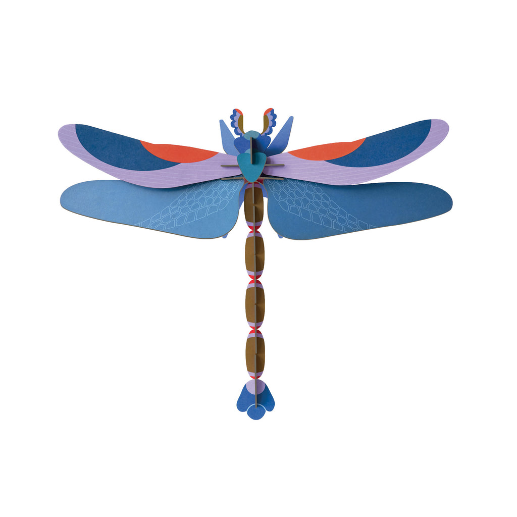 Colorful 3D paper dragonfly art. Features blue and purple wings with orange accents, geometric patterns, and an intricate brown segmented body.