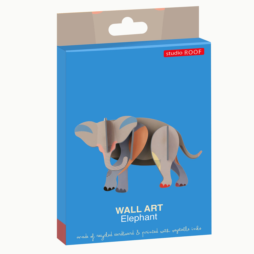 Packaging for elephant wall art made of recycled cardboard, featuring a colorful 3D elephant design. Background is bright blue with a playful tone.
