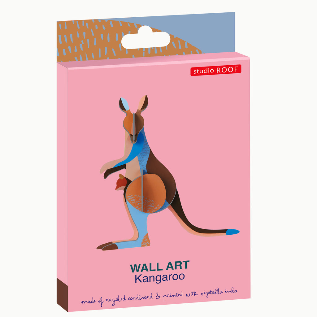 Pink packaging for "studio ROOF" wall art featuring a colorful kangaroo design. Made from recycled cardboard and printed with vegetable inks.