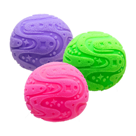 Three textured sensory balls in purple, green, and pink with fuzzy patterns on a white background.