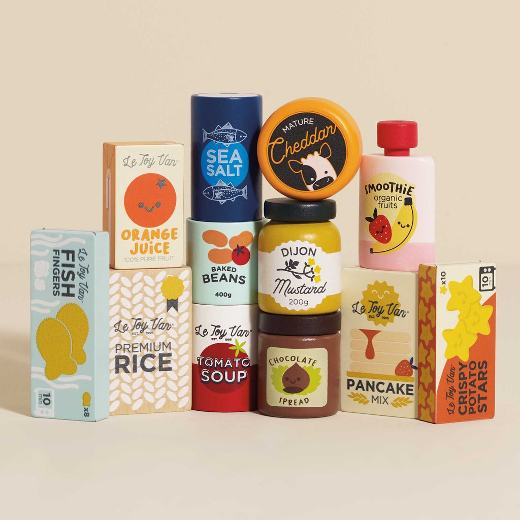 Toy kitchen food set with colorful packaging, featuring items like orange juice, chocolate spread, and cheddar cheese. Playful and cheerful design.