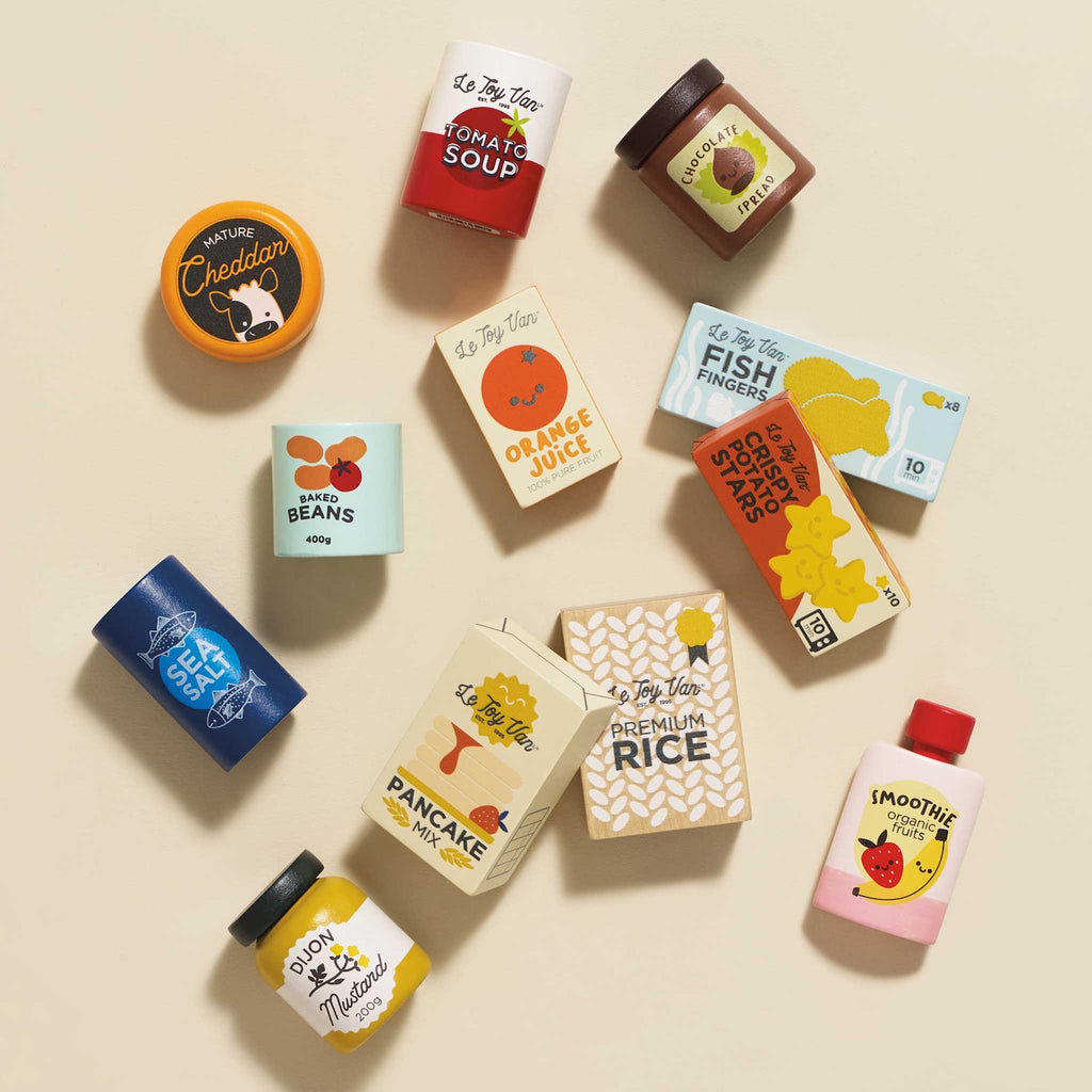 Toy kitchen food set with colorful packaging, featuring items like orange juice, chocolate spread, and cheddar cheese. Playful and cheerful design.